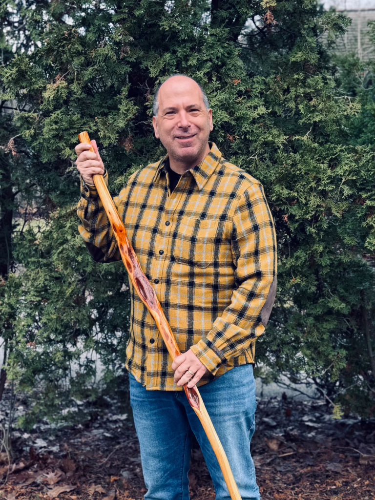 Rabbi Robert A. Nosanchuk with his diamond willow walking stick. Willows endure wounds from weather, fungi and insects. But life doesn’t abandon the damage. It grows around it.